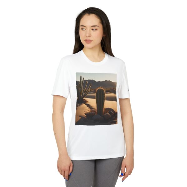 Woman wearing white adidas Desert Vibes Unisex Sport T-shirt while standing – front view